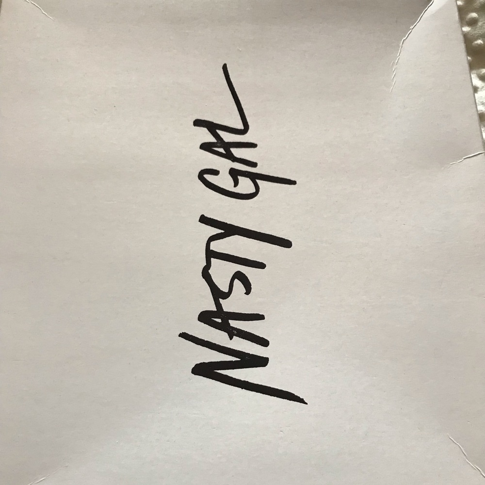 A pair of thigh high Nasty Gal boots.